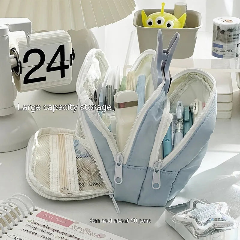 Double layer high capacity pencil case in blue with gift handle, showing zippered compartments.
