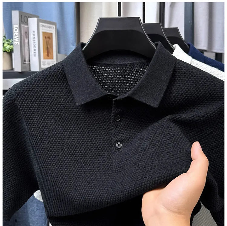 Loose-fitting short sleeve cotton pullover sweater in a neutral colour on a hanger.