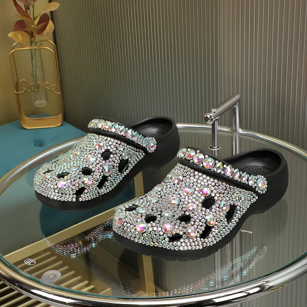 Black women's platform sandals with rhinestone details and a perforated upper on an EVA sole.