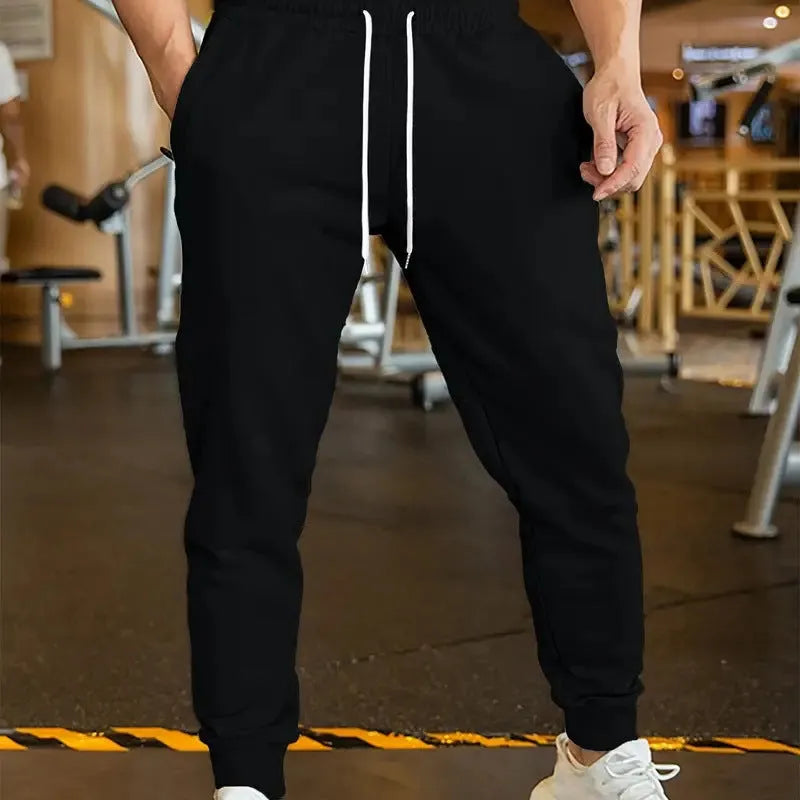 Men's elastic waist leisure trousers with drawstring closure and loose fit in polyester fabric