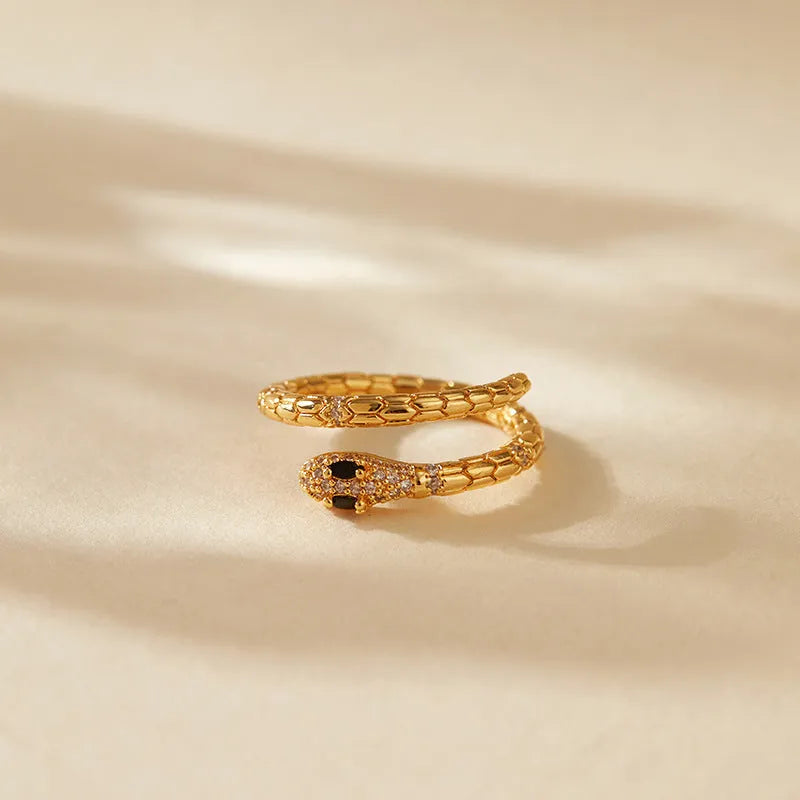 Snake-shaped adjustable copper ring with 18K gold colour retention plating on index finger