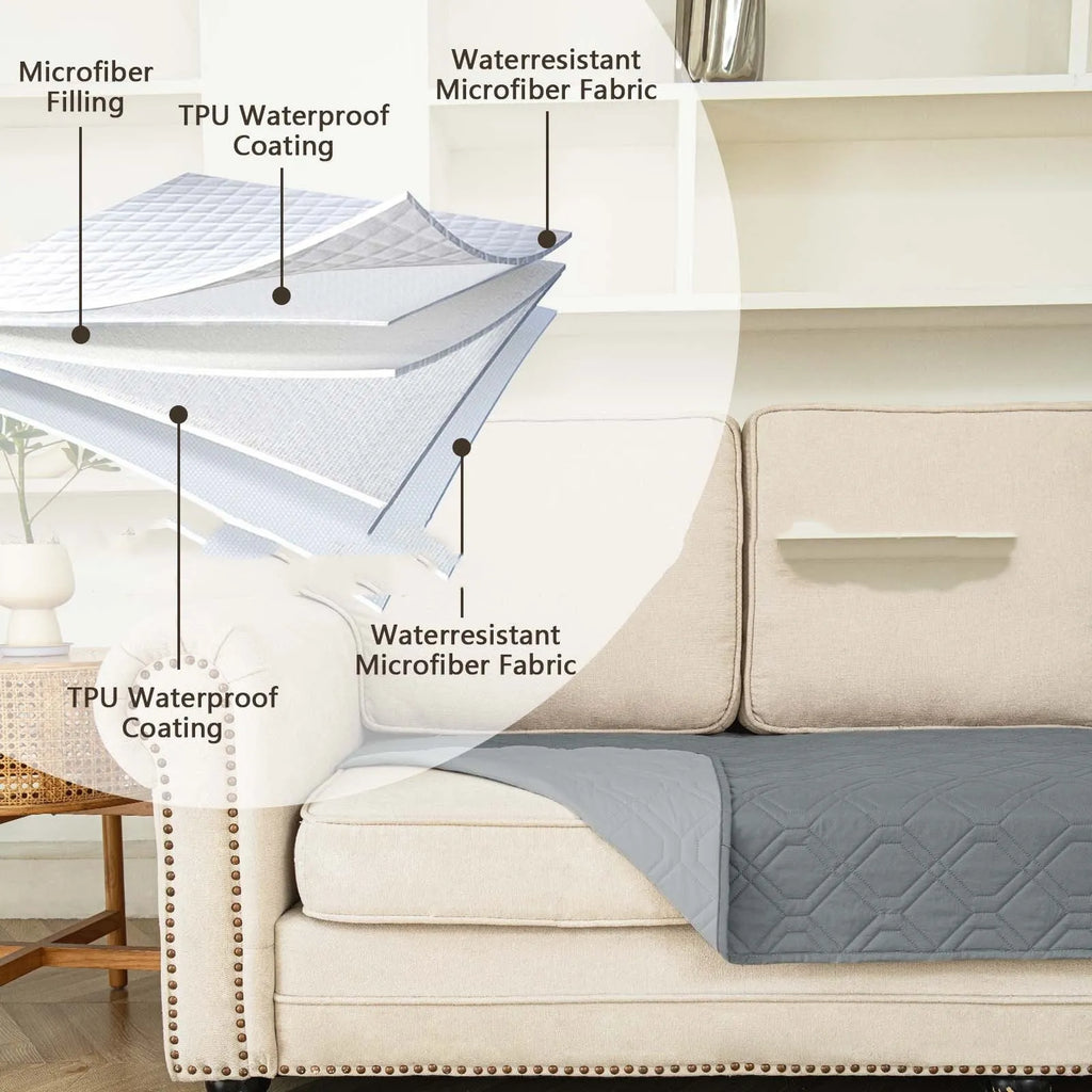 Reversible waterproof dog sofa cushion in dark grey and light grey contrast colours on a sofa.