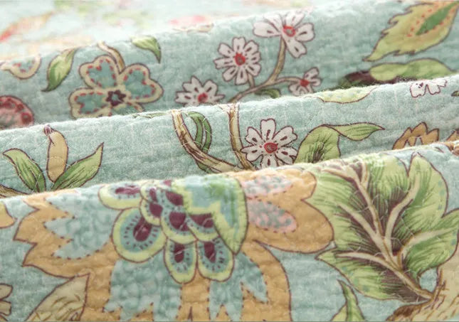 Blue American style cotton bedspread with plant and flower pattern, quilted texture