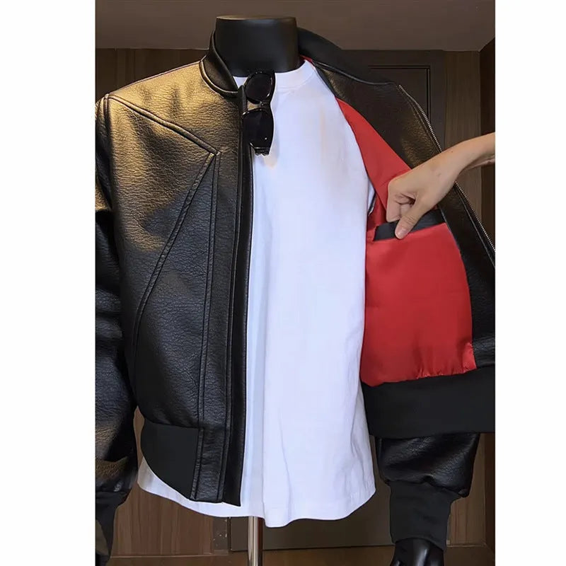 Men's black slim-fit PU leather jacket with extended length and litchi grain texture.