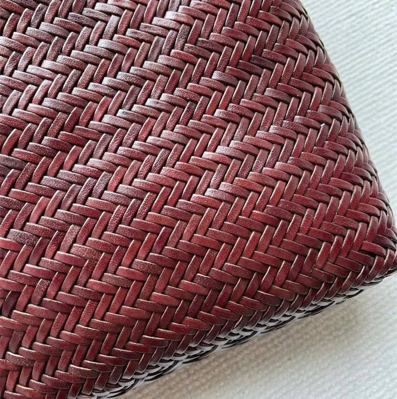 Brown handmade woven leather tote bag with three-dimensional pocket showing vintage texture