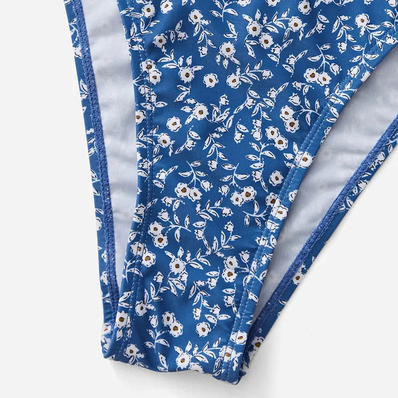 Blue women's swimsuit three-piece set with top and shorts, made from polyester fabric.