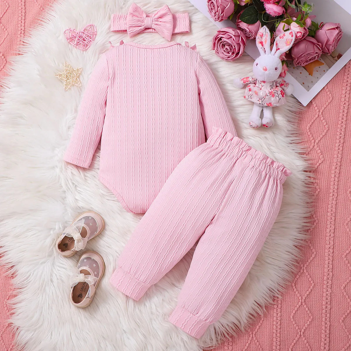 Pink baby girl three-piece set with ribbed frill long sleeve romper, pants, and matching headscarf on white background