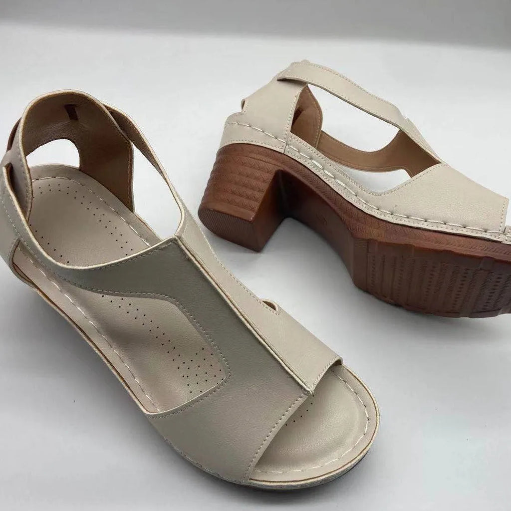 Women's beige peep toe wedge sandals with a buckle ankle strap and low rubber sole.