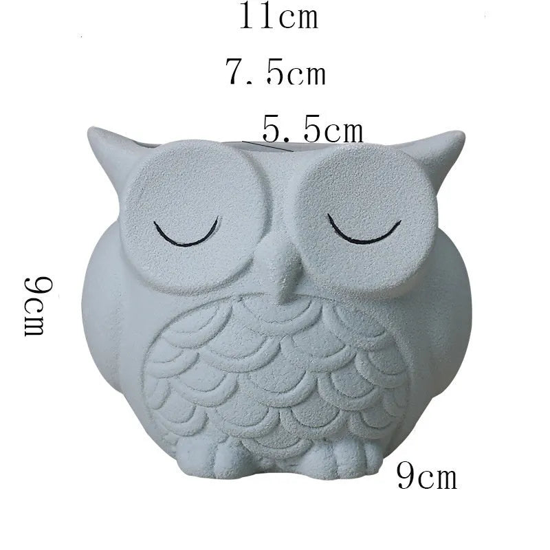 Handmade frosted ceramic succulent pot with cartoon owl design, shown in light pink.