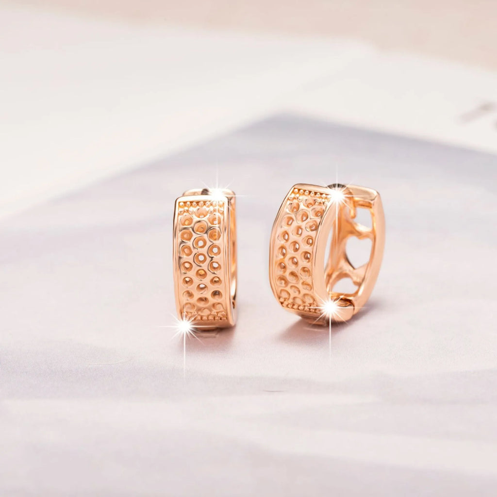 Rose gold hollowed heart earrings with circular shape and electroplated finish