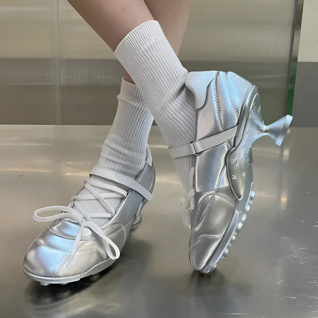 Women's silver lace-up sports shoes with a bow detail and a round toe, shown on a low-top cut.