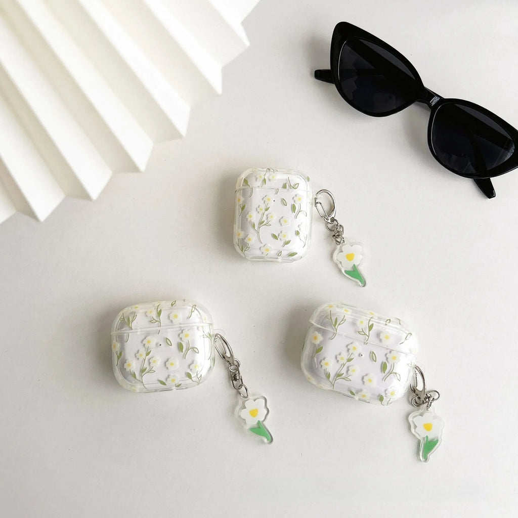 Transparent white floral patterned soft TPU protective case for Apple AirPods on a table.