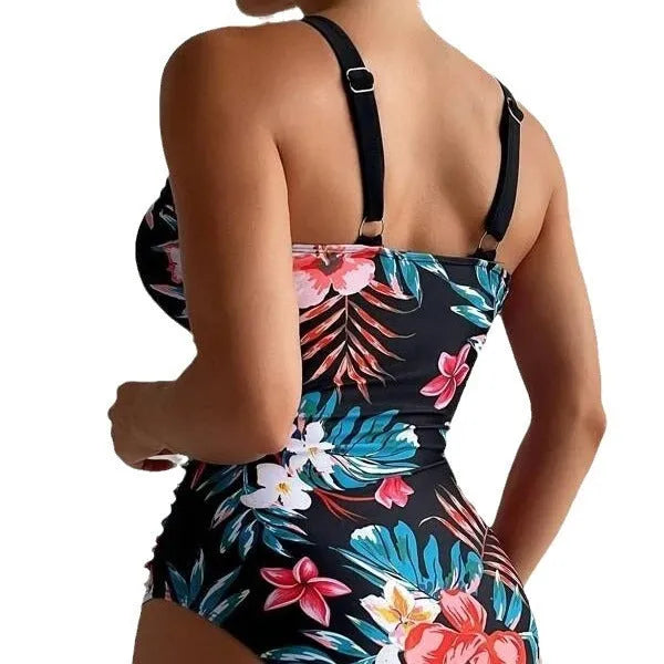Women's floral print backless one-piece swimsuit on a hanger.
