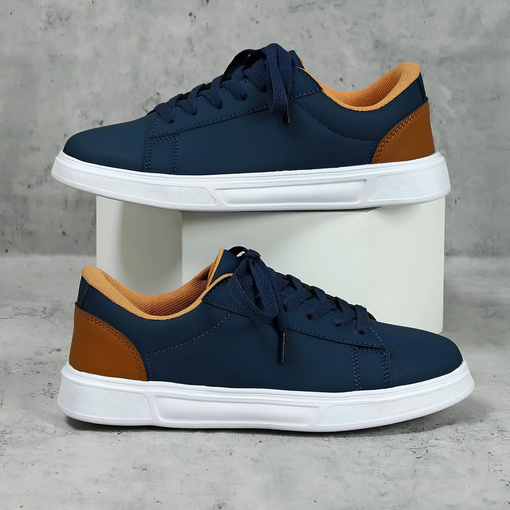 Beige brown casual platform sneakers with cross strap detail and rubber sole.