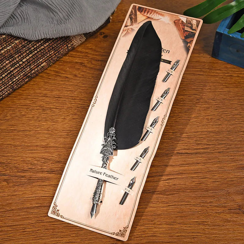 Vintage feather dip pen with zinc alloy shell in various colour options on a desk.