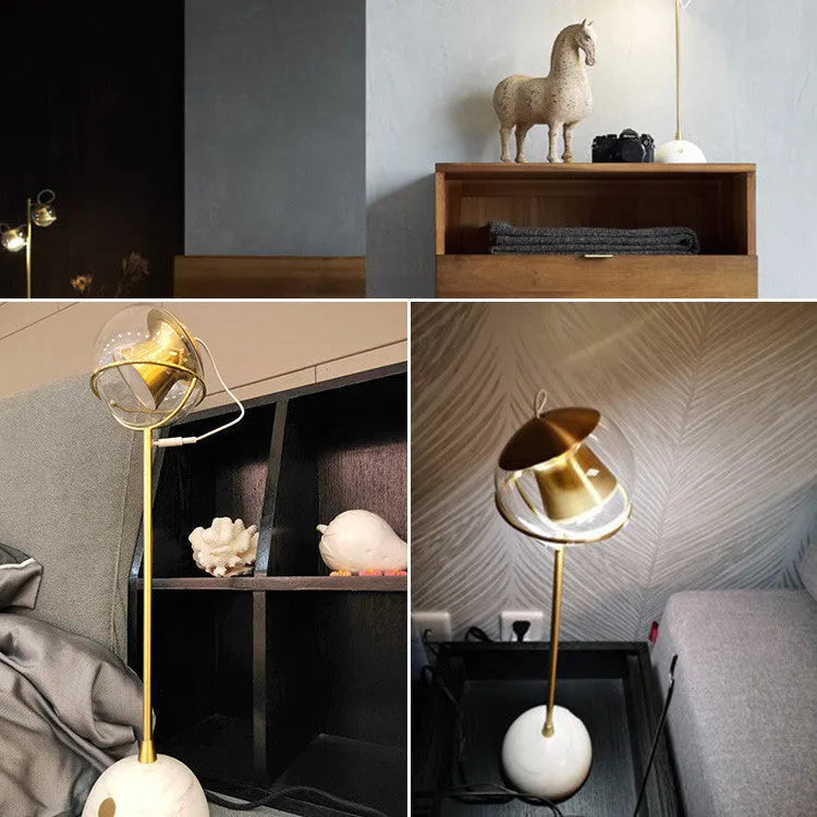 Modern desk lamp with a glass lampshade and touch-sensitive base for dimming control.