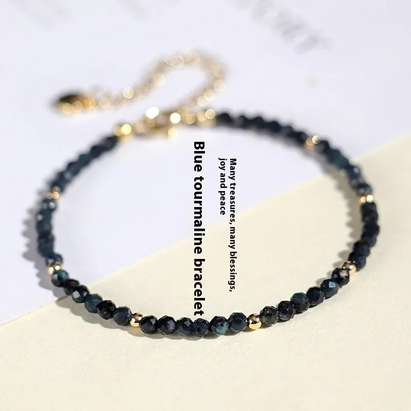 Blue tourmaline 3mm bead bracelet with spacer design on wrist