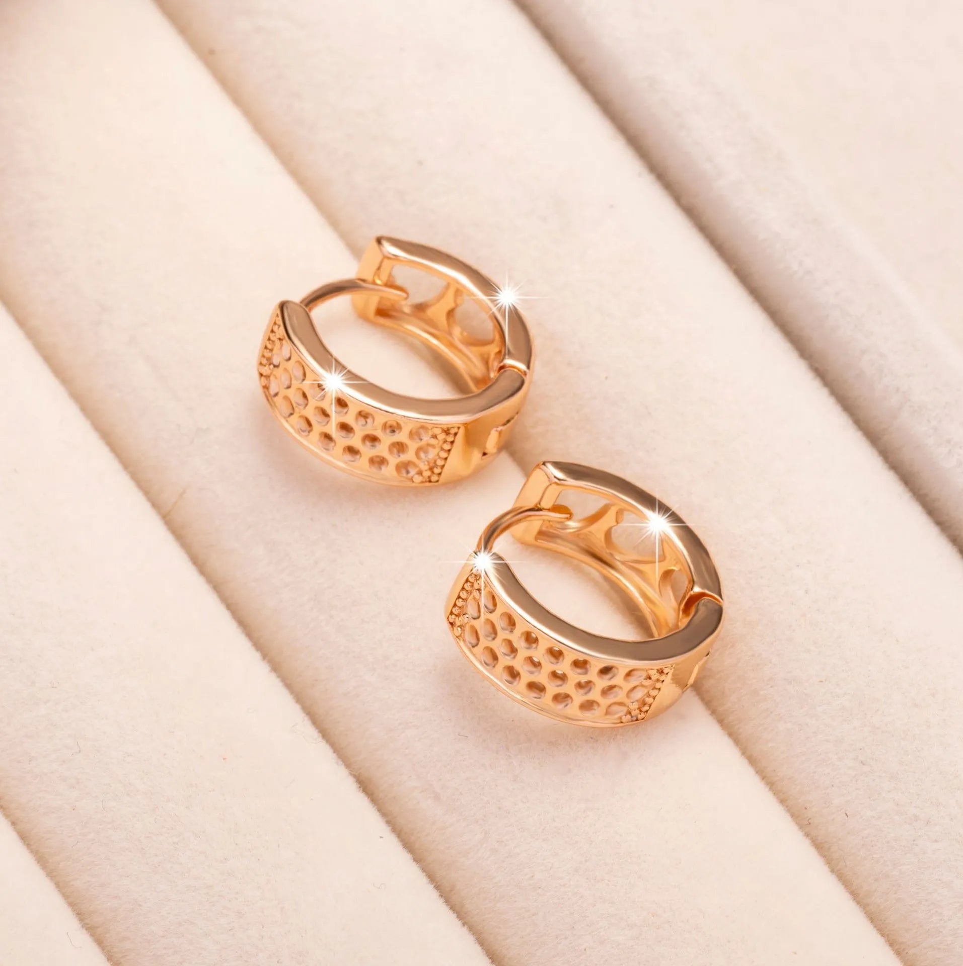 Rose gold hollowed heart earrings with circular shape and electroplated finish