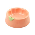 Green plastic pet double bowl with food and water compartments showing anti-tipping design