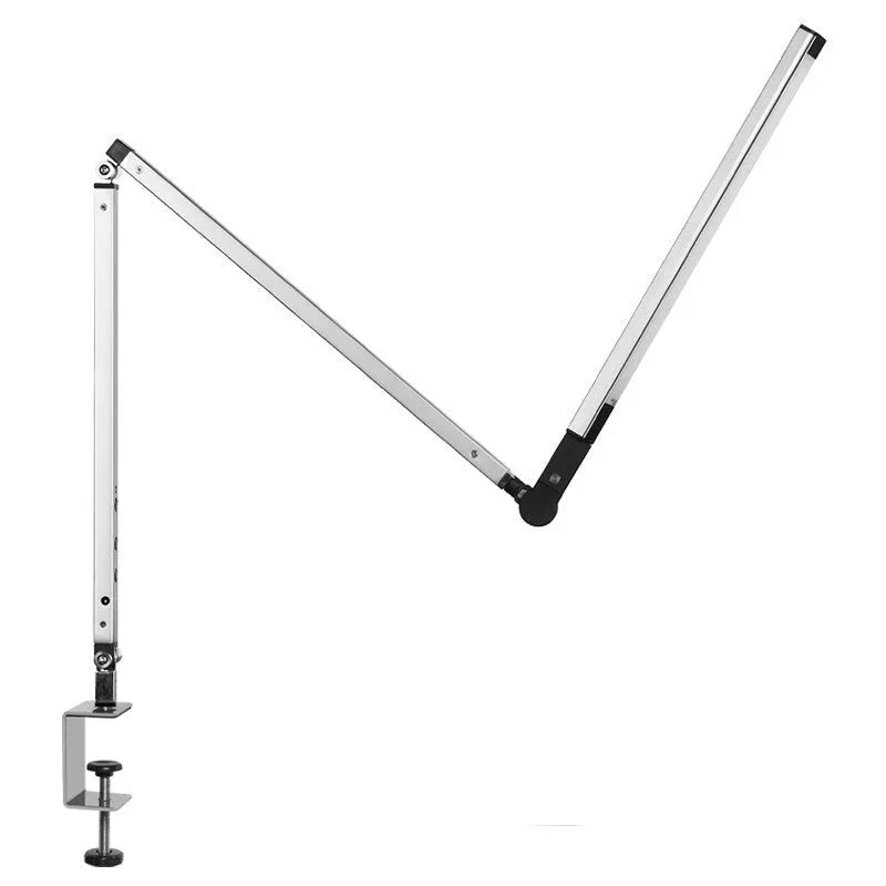 Aluminium LED desk lamp with a folding clip, remote control, and black finish on a desk.