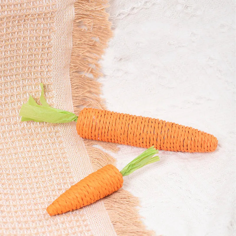 Assortment of interactive cat toys including carrot bites, paper toys, ringing stones, sticks, and grinding toys