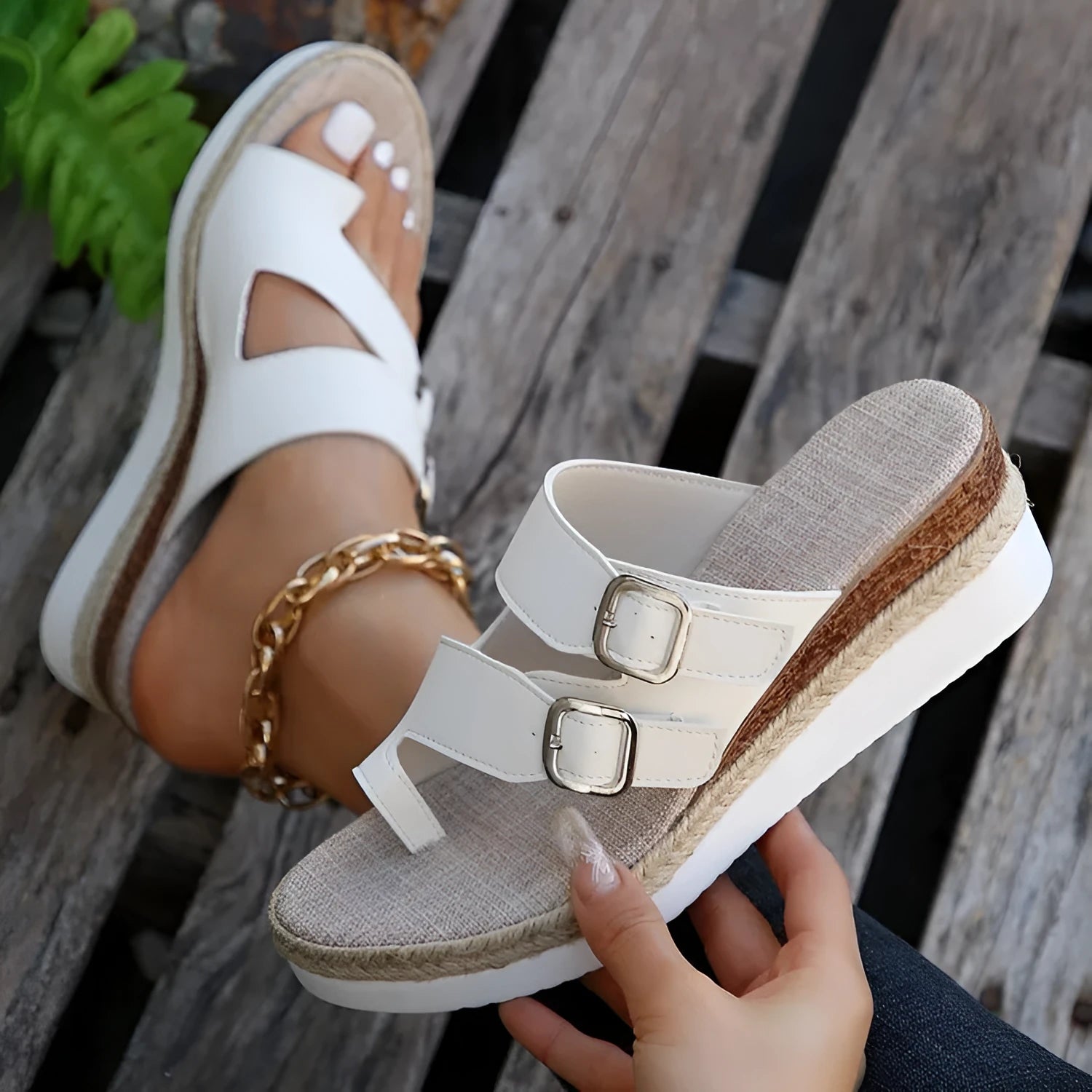 White women's wedge sandals with a woven patent leather upper, peep toe, and a finger-fit ankle strap on a rubber sole.