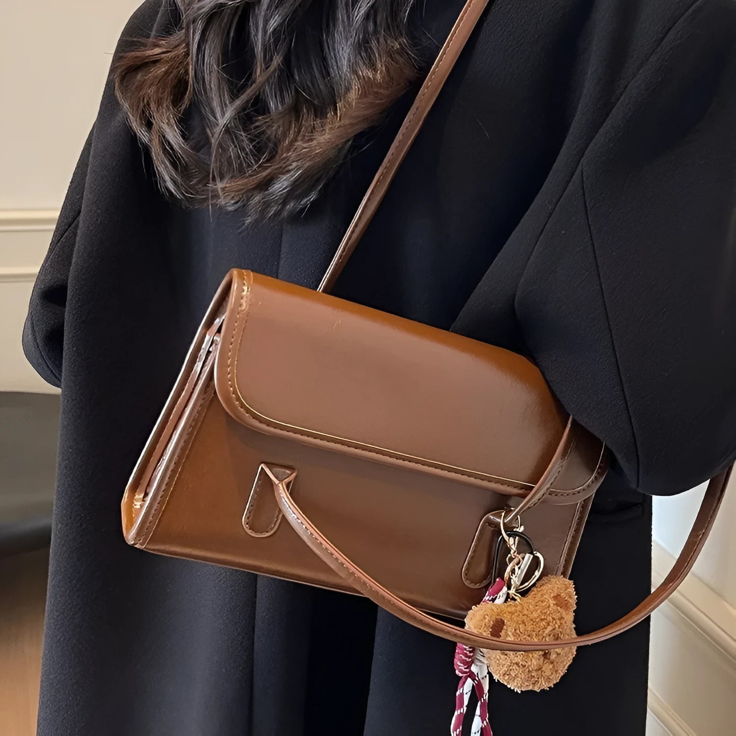 Brown structured women's PU shoulder bag with double straps, a pendant, and a horizontal square shape.