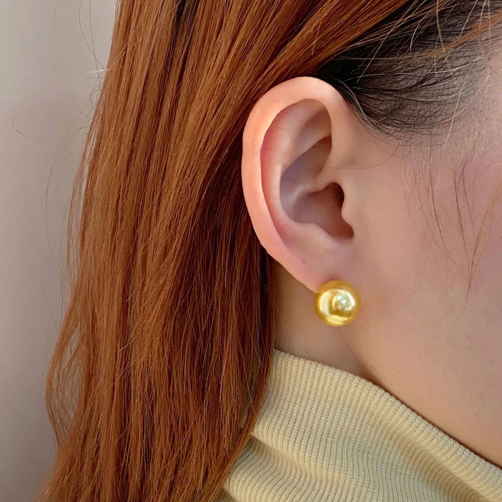 Large pearl stud earrings with geometric silver settings and eight-pointed star details