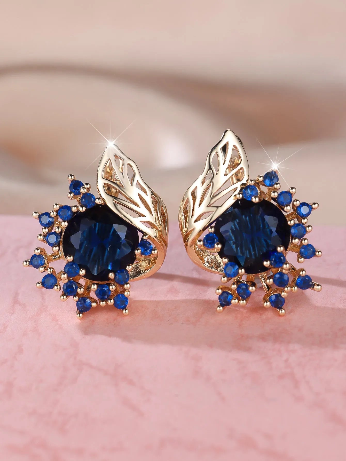 Round flower feather design earrings with champagne gold setting and coloured zircon stones.