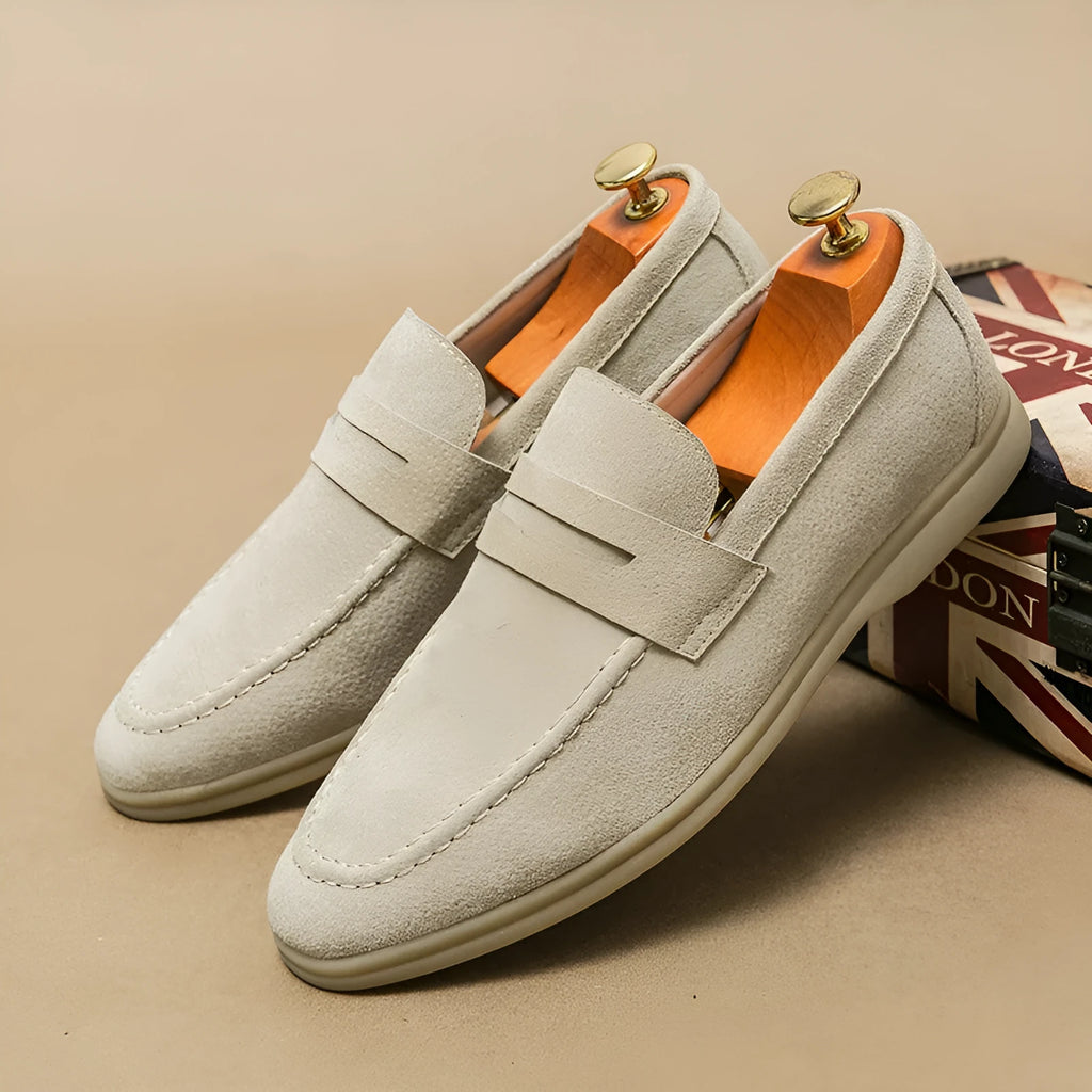 Men's black leather slip-on shoes with round toe and oversleeve design on a rubber sole
