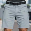 Man wearing solid colour straight-leg shorts in micro-elastic polyester fabric.