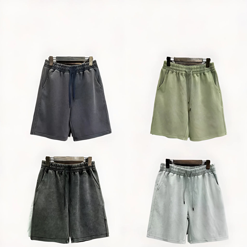 Man wearing navy blue cotton shorts with a distressed finish and a loose, straight-leg casual fit.