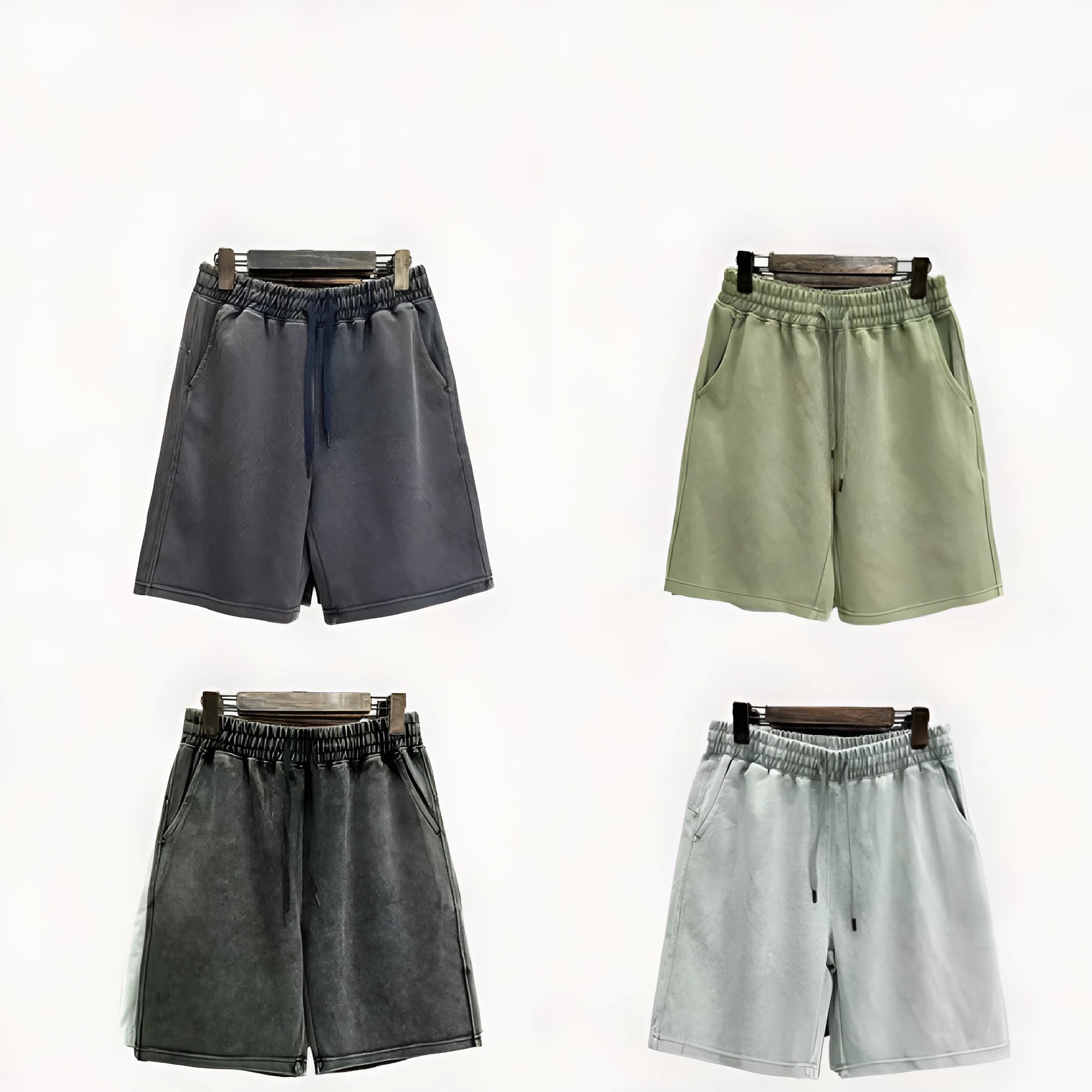 Man wearing navy blue cotton shorts with a distressed finish and a loose, straight-leg casual fit.
