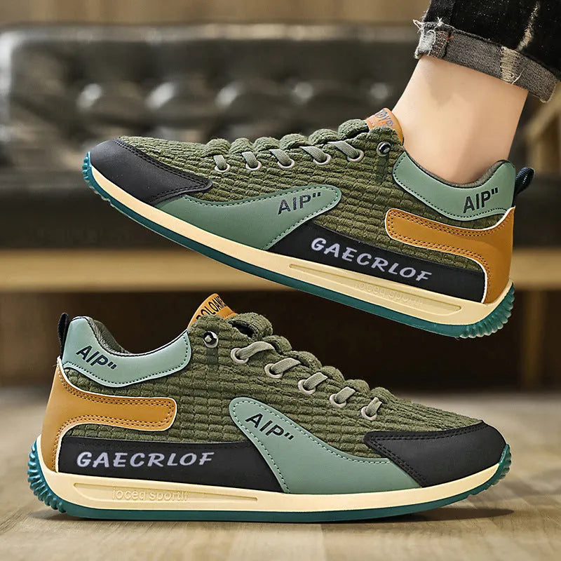 Men's grey and green mesh low-top lace-up running shoes on a white background.