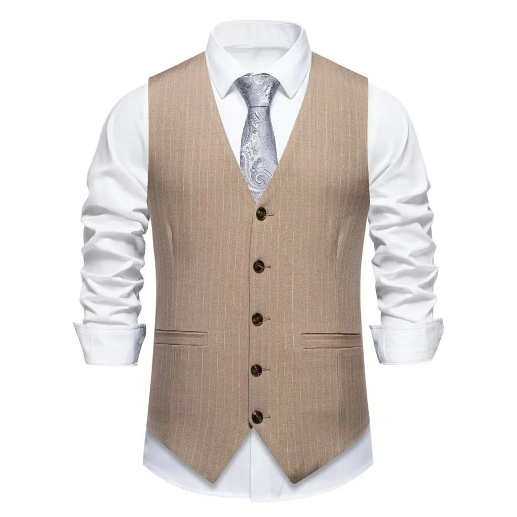 Man wearing a striped suit vest in a formal setting, showing the mitered bottom hem and pocket detail.