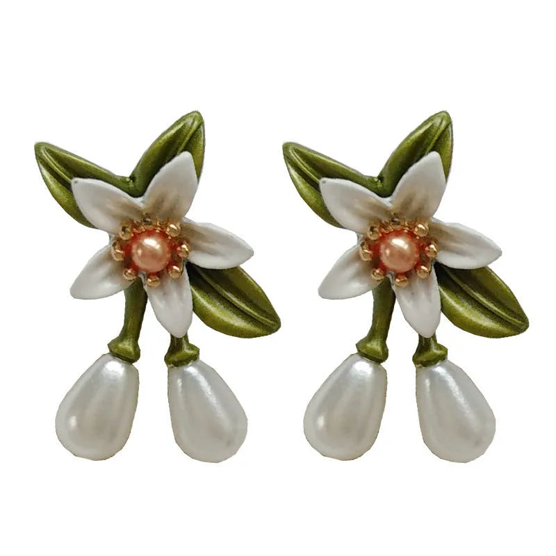 A pair of alloy flower earrings for women, shown in sterling silver needle flowers and flower ear clip styles.