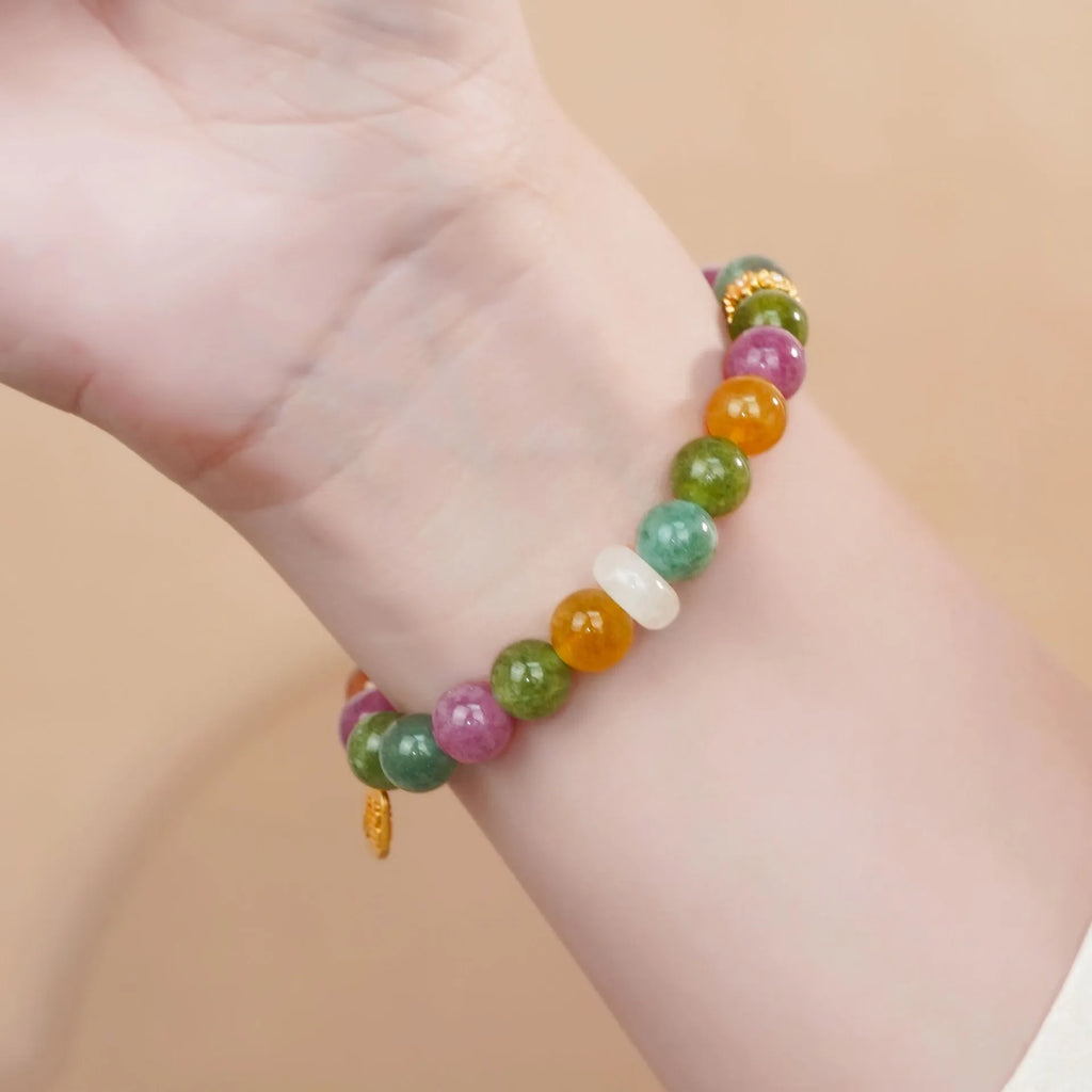 Rainbow tourmaline half-bracelet for women with natural jade colours and electroplated metal setting.