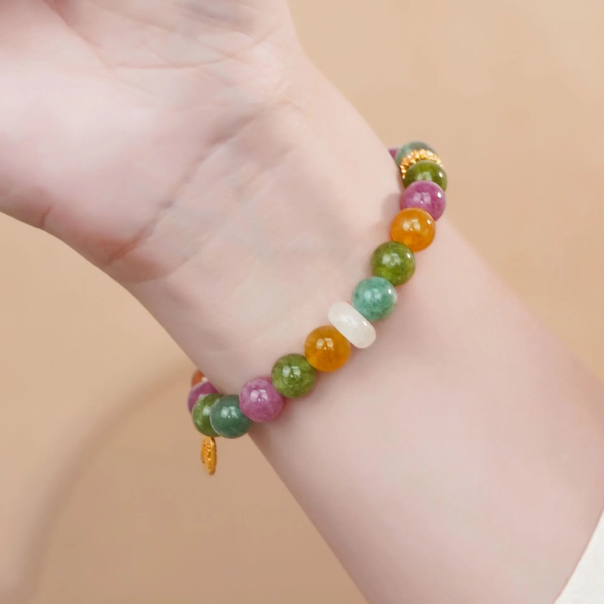 Rainbow tourmaline half-bracelet for women with natural jade colours and electroplated metal setting.