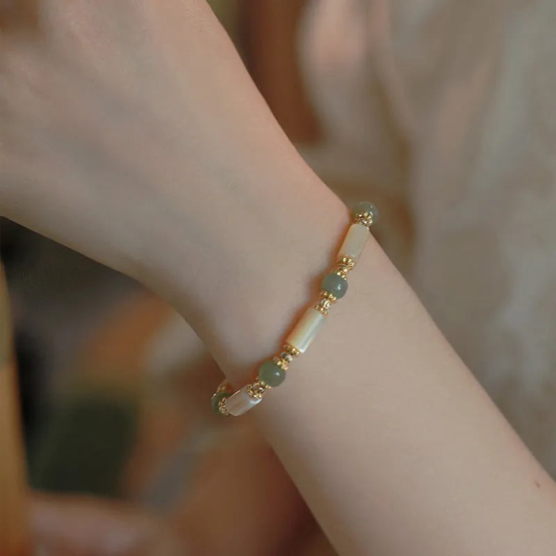 Handmade Hetian jade white lip shell bracelet with round beads on wrist