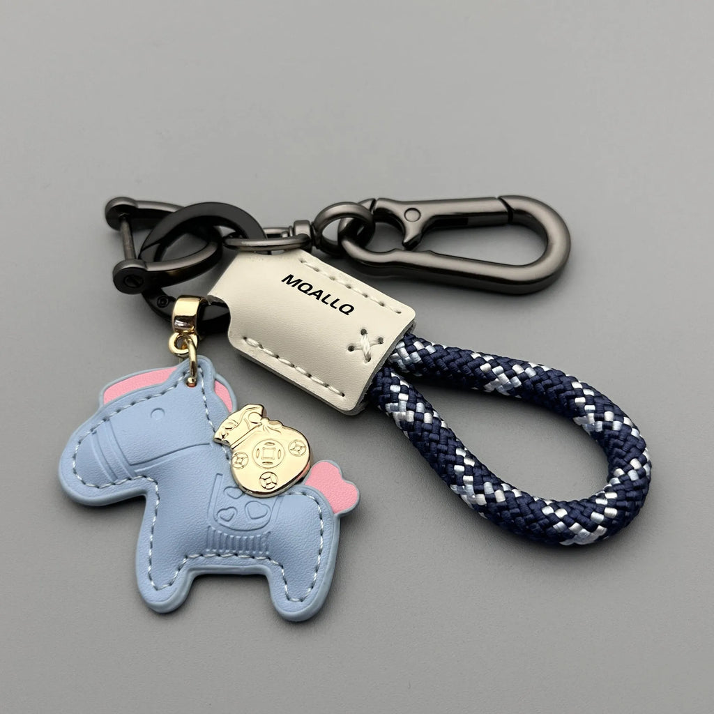 Handmade cowhide car keychain pendant with a zinc alloy pony buckle and coloured flanelle rope strap.