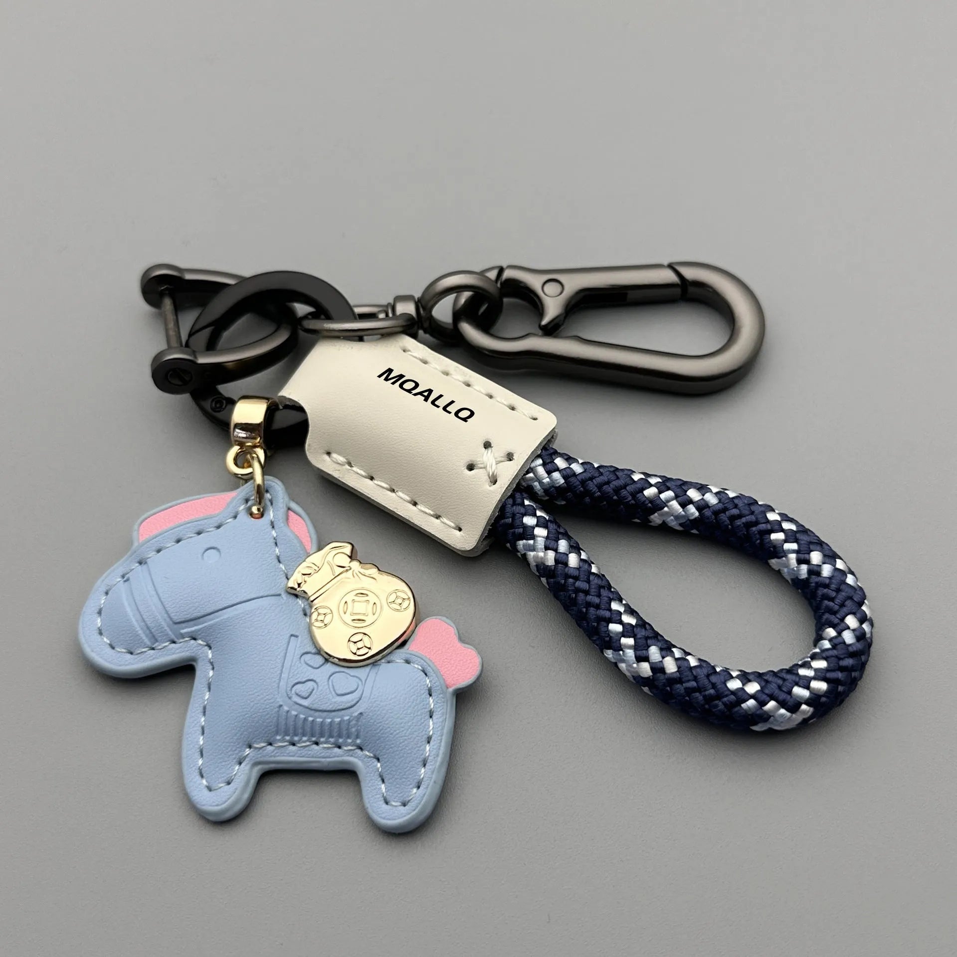 Handmade cowhide car keychain pendant with a zinc alloy pony buckle and coloured flanelle rope strap.