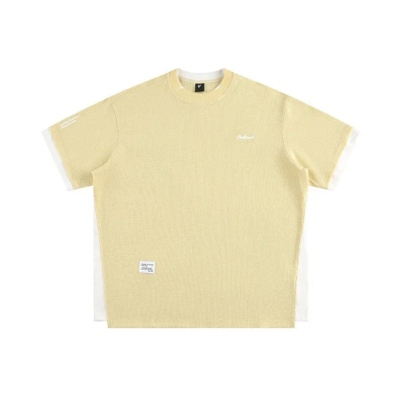 Loose-fitting short-sleeved waffle t-shirt with retro alphabet embroidery in yellow.