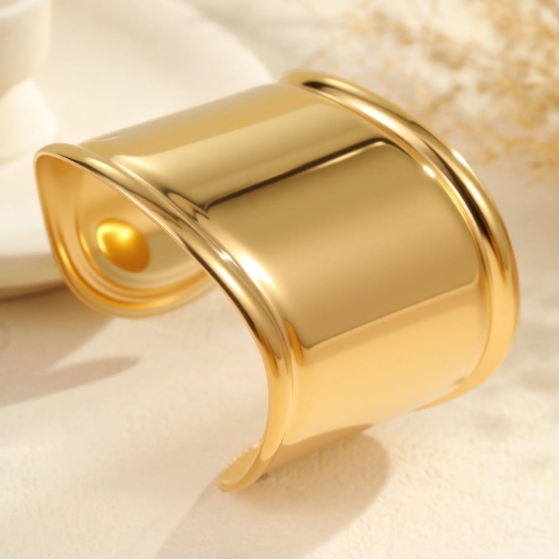 Women's wide fashion bracelet with gold plating and geometric wave design