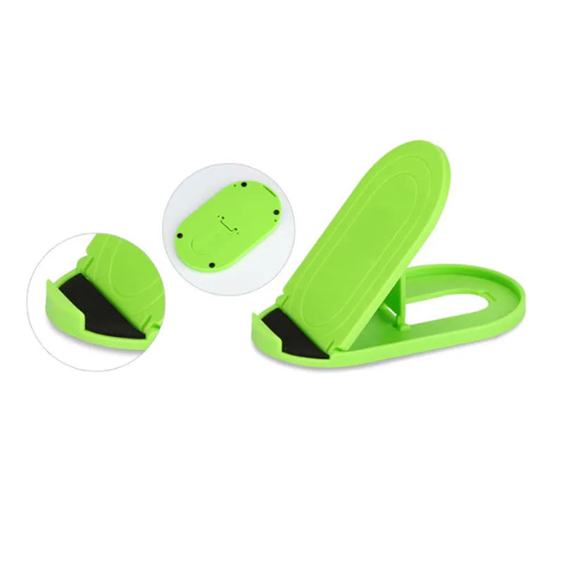 Adjustable plastic mobile phone stand in multiple colours on a table, holding a smartphone at an angle