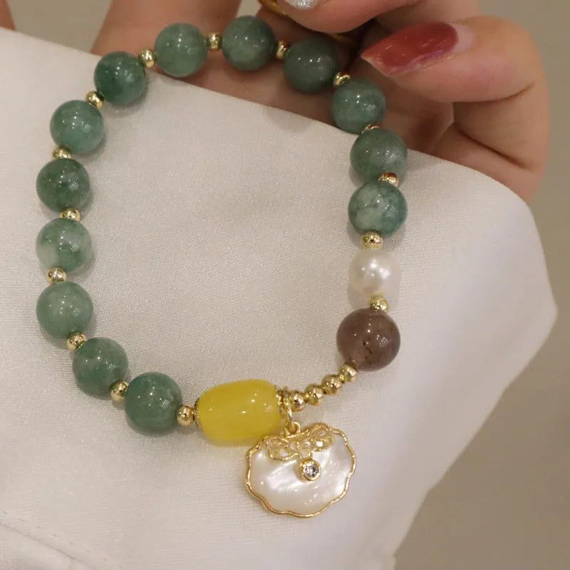 Natural green jade and shell bead bracelet with adjustable cord for women.