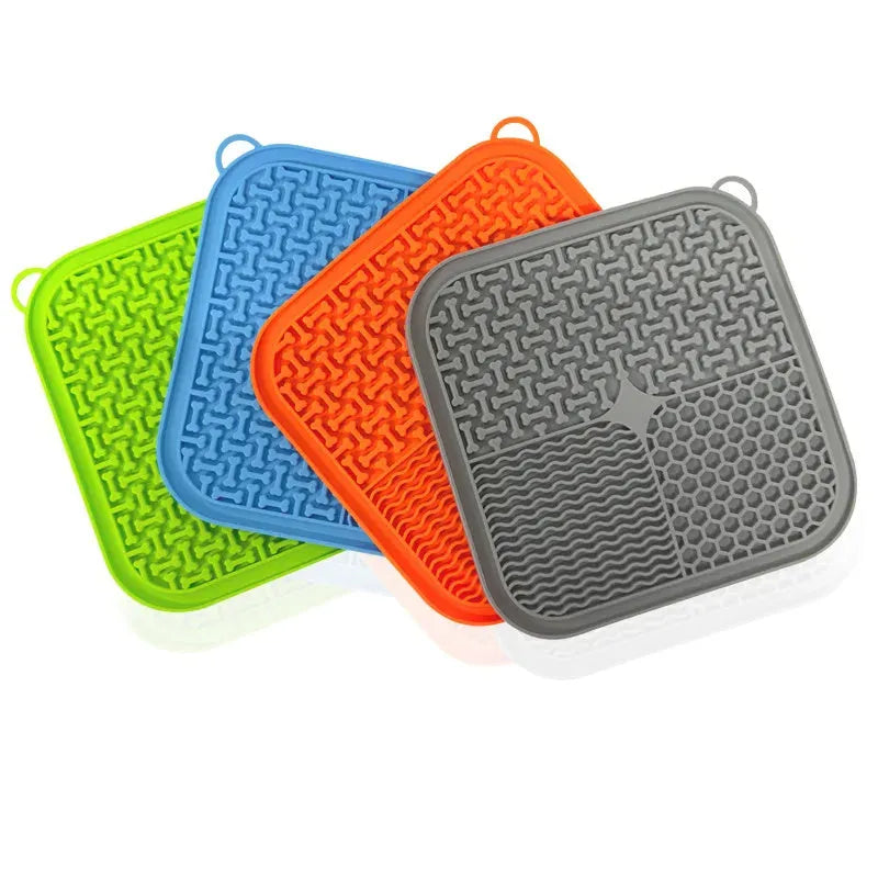 Orange red silicone dog licking mat with textured surface and suction cups on back