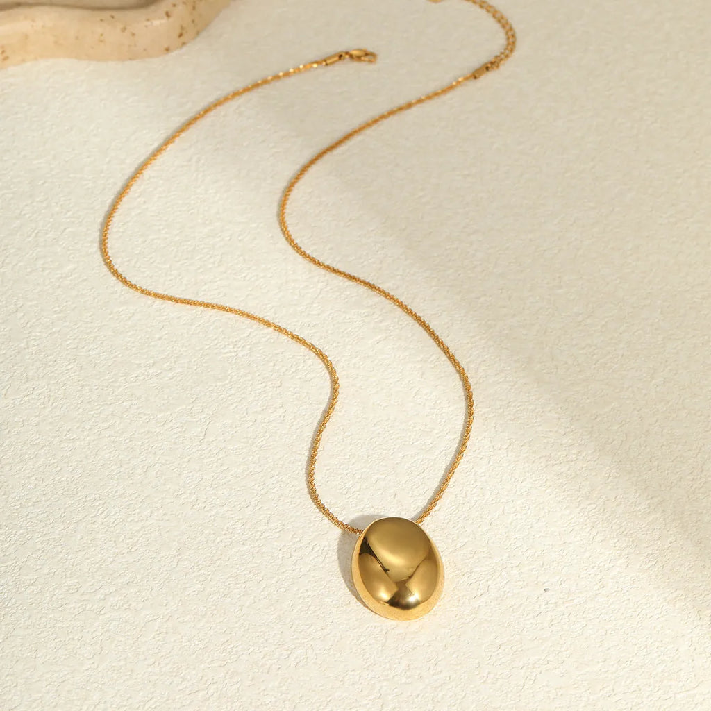 Geometric gold pendant on adjustable stainless steel chain necklace with regular links