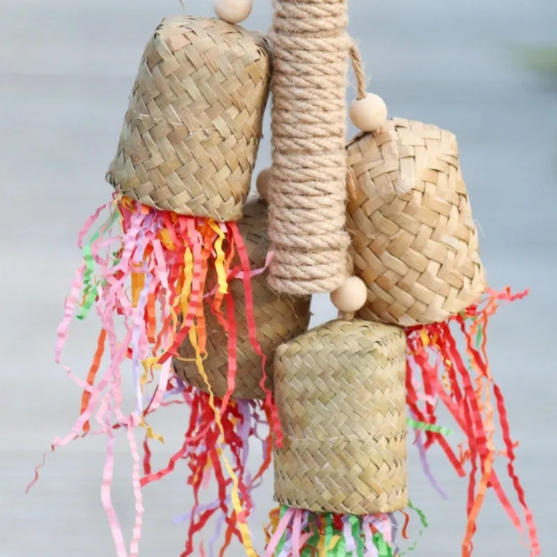 Colourful shredded paper hanging bird toy made of wood and sisal for parrots.