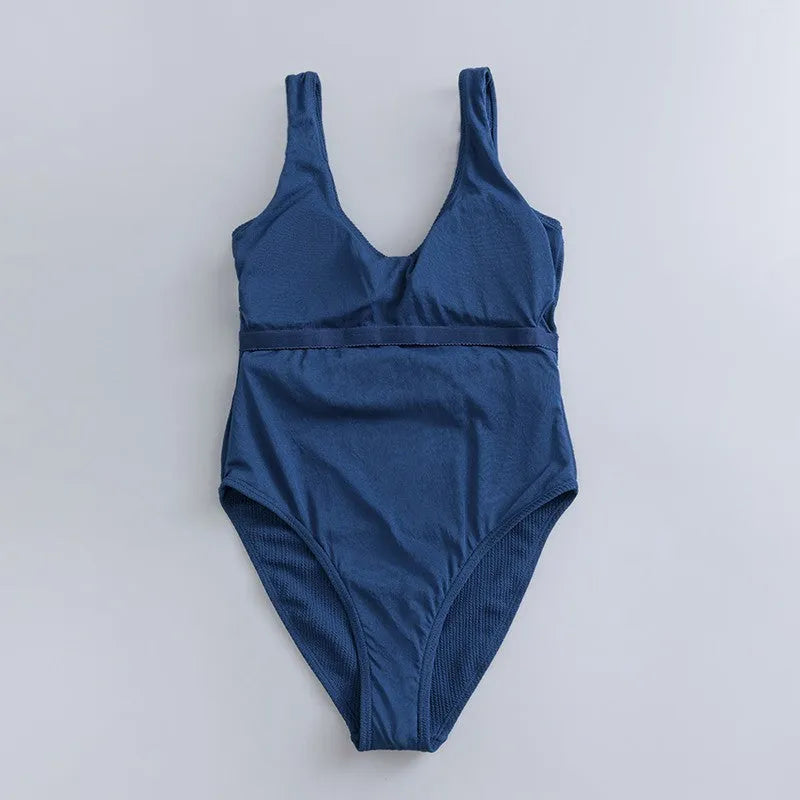 Navy blue one-piece women's swimsuit with triangle design and chest pads on a mannequin