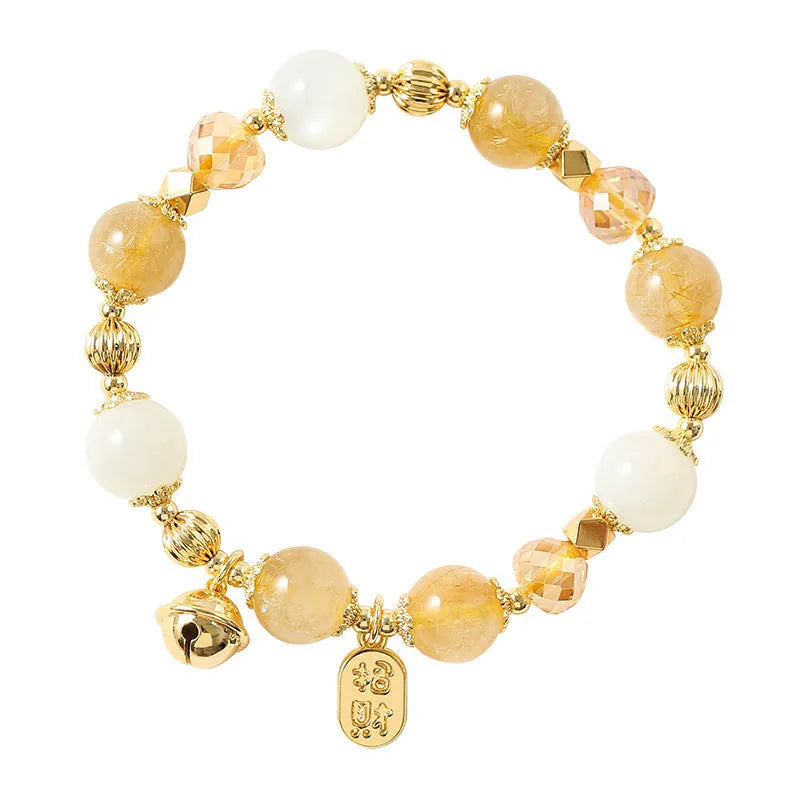 Gold coloured rutilated quartz bracelet with Korean style design on wrist
